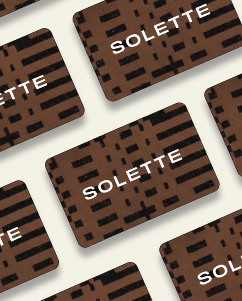 overhead shot of several solette gift cards placed in a bricklike pattern